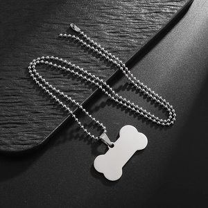 Silver bone-shaped stainless steel pendant necklace with bead chain on black background