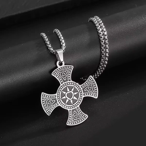 Polished silver celtic cross pendant with heart engraving on black display pedestal