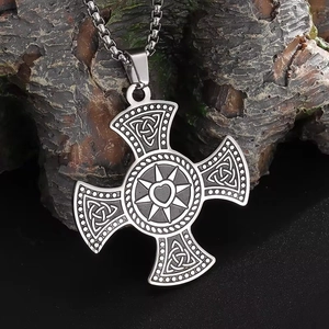 Macro detail of silver stainless steel Celtic cross necklace with heart sun and knot textures