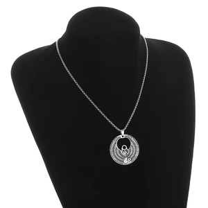 Gros plan détaillé du pendentif déesse égyptienne Isis sur un support de mannequin noir