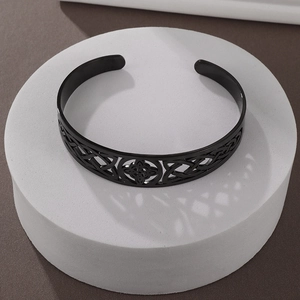 Detail view of black Celtic knot hollow engraved stainless steel cuff bracelet