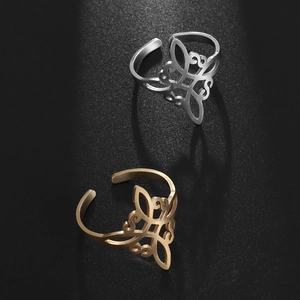Adjustable stainless steel Celtic knot rings in gold and silver finish on black background