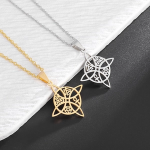 Detail of hollow witch knot pendants in gold and silver finish with mystical symbols