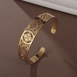 Detailed macro view of 18K gold-plated Celtic knot hollow design on stainless steel cuff