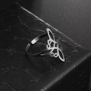 Detailed macro view of the silver Celtic knot cutout pattern on an open steel ring