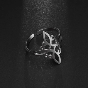 Macro detail of silver stainless steel Irish knot open ring with hollow geometric pattern