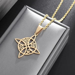 Macro shot of gold stainless steel necklace featuring a hollow mystical symbol pendant