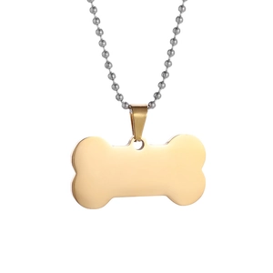 Polished gold bone-shaped pet ID tag with a silver ball chain on a white background