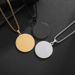 Detail view of round polished pendant necklaces in gold black and silver stainless steel