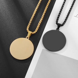 Detail showing polished gold and black round metal pendants with box chain necklaces