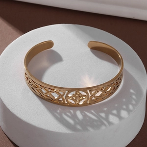Detailed top view of gold-plated stainless steel open bangle with intricate Celtic knot patterns