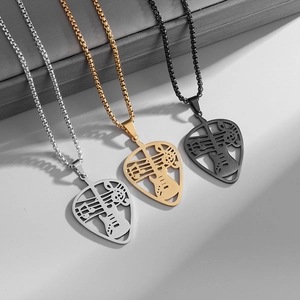 Close-up of guitar pick necklaces in silver, gold, and black with musical note cutouts