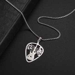 Macro view of polished stainless steel guitar pick necklace with hollow musical notes