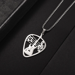 Detailed close-up of a silver guitar pick pendant with music note cutouts on a box chain