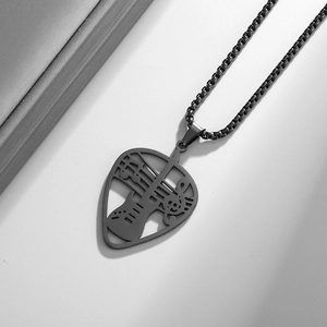 Detailed macro view of hollow guitar and music note pendant in matte black stainless steel