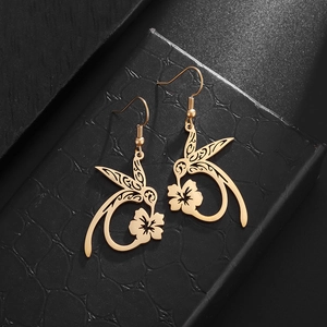 Close-up of golden hummingbird flower drop earrings on black leather jewelry box