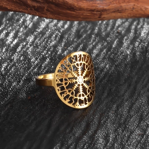 Detail of vintage golden stainless steel ring featuring cutout Viking Vegvisir symbol
