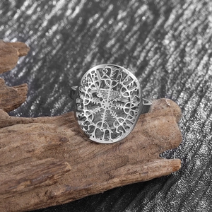 Macro shot of silver Viking Vegvisir compass ring with hollow details on wood