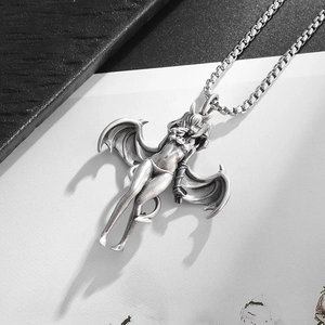Close-up of a silver anime succubus girl pendant with bat wings on a box chain
