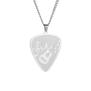 Detailed macro view of heart-shaped guitar pick pendant with music note and heartbeat lines