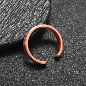 Macro shot of copper magnetic therapy ring featuring vintage hammered texture finish