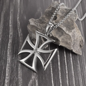 Detailed close-up of a hollow iron cross pendant with silver finish on a box chain