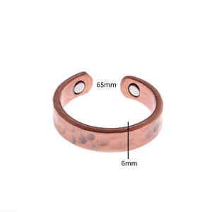 Macro shot of copper magnetic therapy ring with hammered texture and 6mm width detail