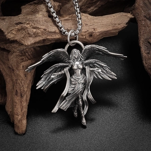 Close-up of vintage silver alloy six-winged angel pendant with intricate feather details