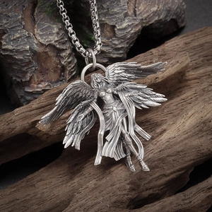 Macro detail of gothic seraphim angel pendant necklace with vintage silver finish