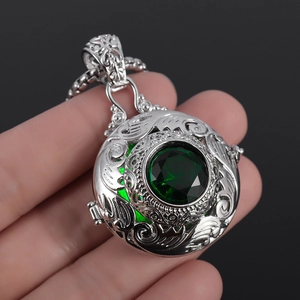 Vintage silver-plated necklace with intricate relief and large green round gemstone pendant