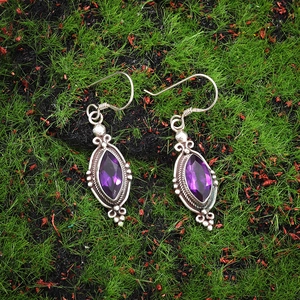 Detail of marquise-cut purple amethyst earrings with vintage silver beaded metalwork
