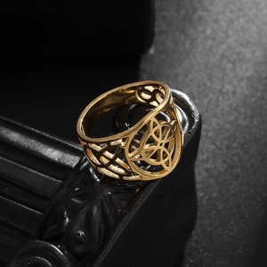 Macro shot of vintage gold Celtic knot hollow design on stainless steel ring with dark textures
