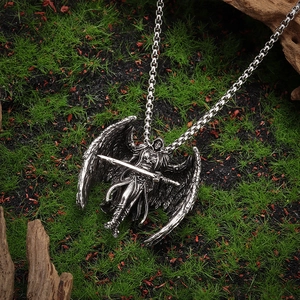 Vintage silver Archangel Michael pendant necklace with wings and sword on moss background