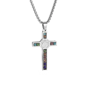 Detailed macro view of silver cross pendant with colorful zircon stones and medallion
