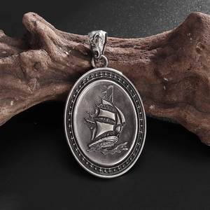 Macro detail of antique silver pirate ship pendant with embossed star pattern on wood