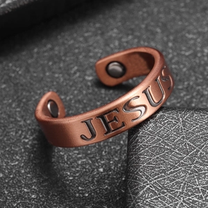 Macro detail of copper Jesus ring featuring matte finish and therapy magnets