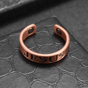 Macro shot of copper Jesus ring featuring vintage matte finish and magnetic details