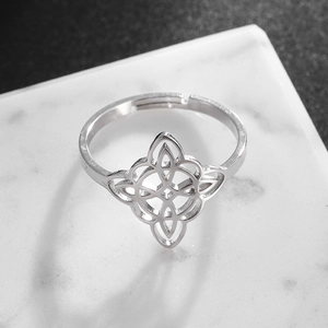 Macro shot of silver stainless steel Celtic witch knot ring with open adjustable band