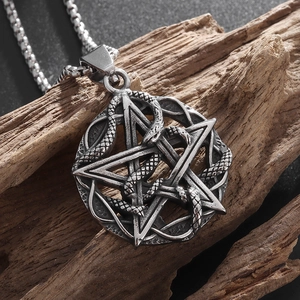 Retro gothic snake coiled around pentagram pendant necklace on wood background