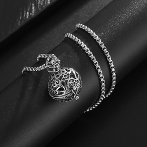 Macro detail of vintage hollow out silver plated copper censer pendant with floral patterns