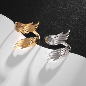 Detailed view of adjustable angel wing rings in polished gold and silver steel finish