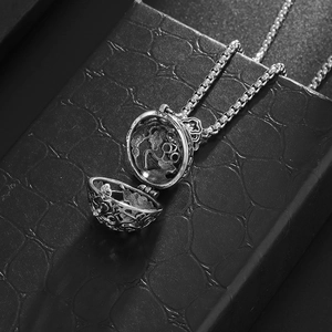 Vintage hollow aromatherapy locket necklace in antique silver finish on a black display box