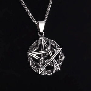 Close-up of retro silver snake entwined pentagram pendant with metallic texture