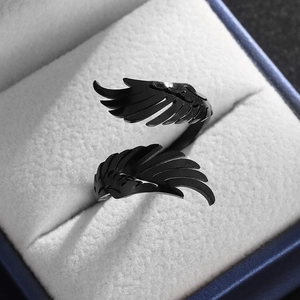 Macro detail of a black adjustable stainless steel wing ring in a jewelry box display