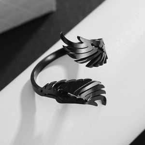 Macro shot of black plated wing ring showing detailed feather texture on the band