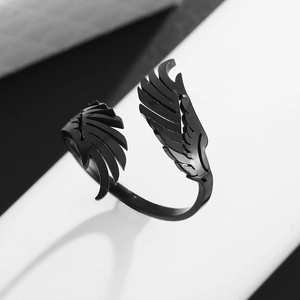Detail view of black stainless steel wing ring featuring an adjustable open band design