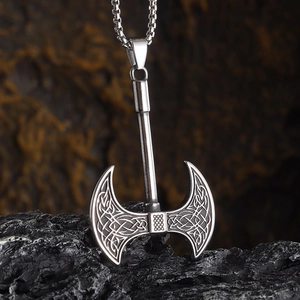 Detail of Celtic knot engraving on a silver axe pendant with a sturdy ball chain