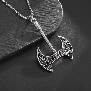 Macro view of vintage silver Celtic axe pendant with detailed knotwork and box chain