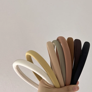 Solid color thick sponge padded headbands in various neutral tones with twill fabric texture