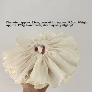 Detail of 22cm oversized cream organza scrunchie showing ruffled texture and dimensions